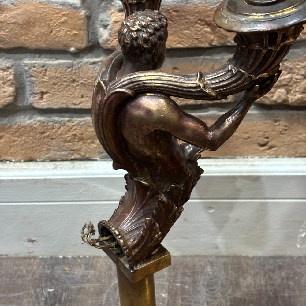 A pair of dark bronze Neoclassical table lamps featuring merman figures supporting twin cornucopia arms on square bases. View VI