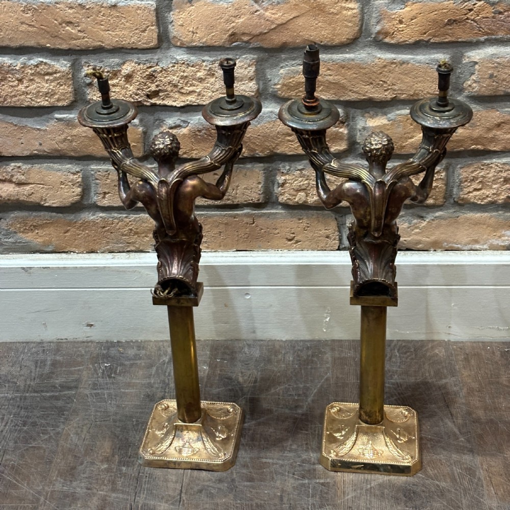 A pair of dark bronze Neoclassical table lamps featuring merman figures supporting twin cornucopia arms on square bases. View VII