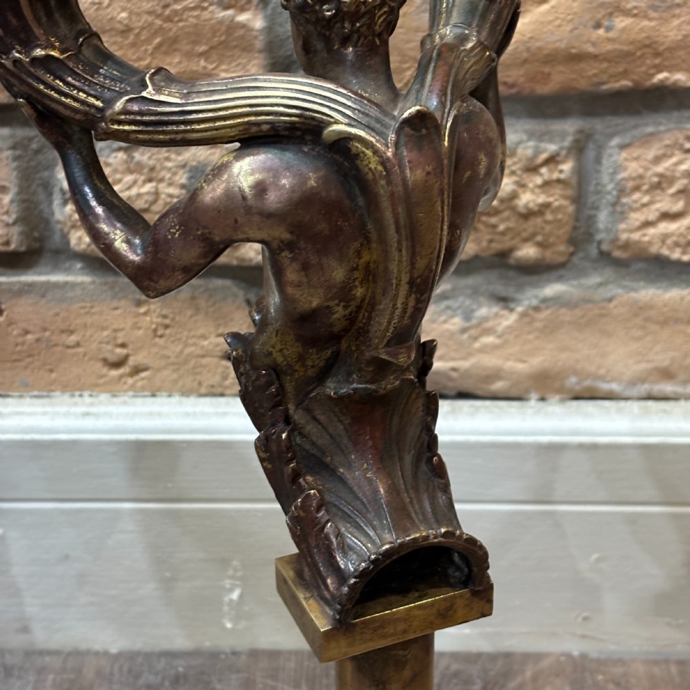A pair of dark bronze Neoclassical table lamps featuring merman figures supporting twin cornucopia arms on square bases. View VIII
