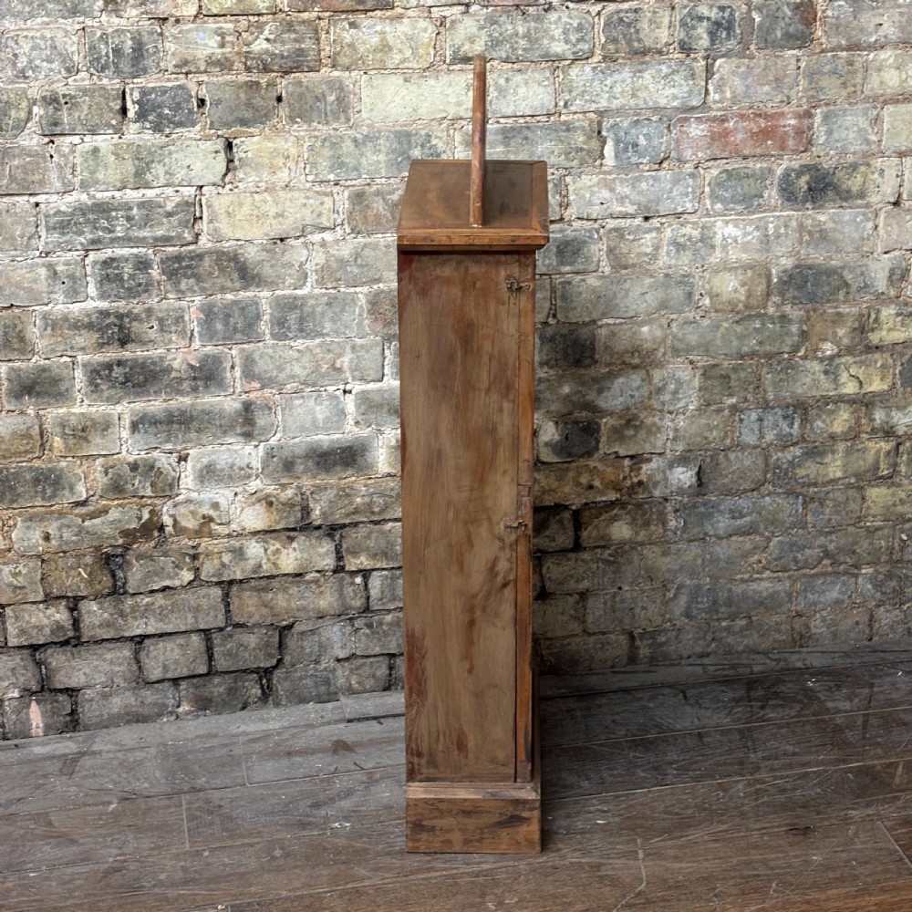 A tall, narrow mahogany advertising display cabinet featuring white glass panels with gold lettering for Frys Chocolate and an arched painted crest. View V