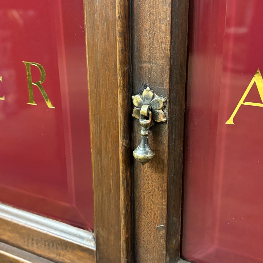 An early 20th-century mahogany office cabinet featuring four maroon panels with gold hand-lettering reading Farrer and Co Barristers Solicitors. View IV