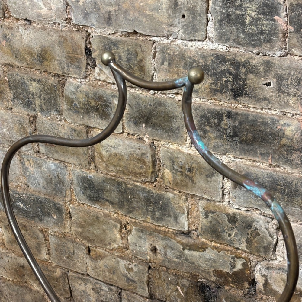 An early 20th-century brass drapers display stand featuring a wire bust frame on an adjustable central column with a heavy fluted cast iron base. View II