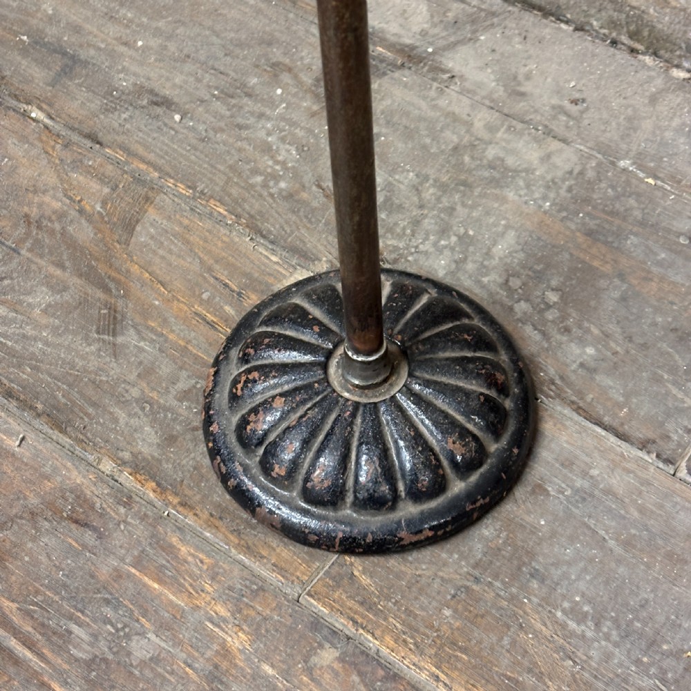 An early 20th-century brass drapers display stand featuring a wire bust frame on an adjustable central column with a heavy fluted cast iron base. View III