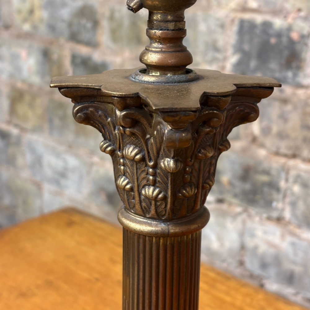 A cast brass table lamp base designed in the form of a fluted Corinthian column on a stepped square plinth. View IV