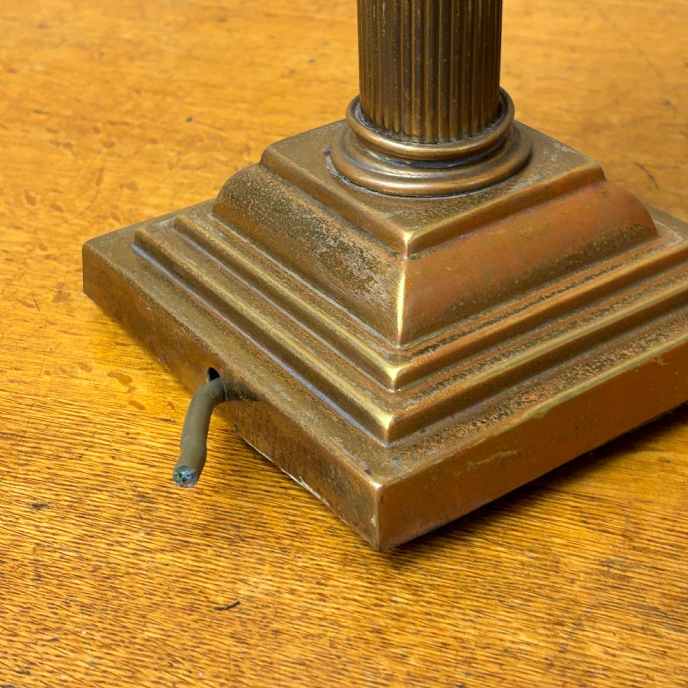 A cast brass table lamp base designed in the form of a fluted Corinthian column on a stepped square plinth. View V