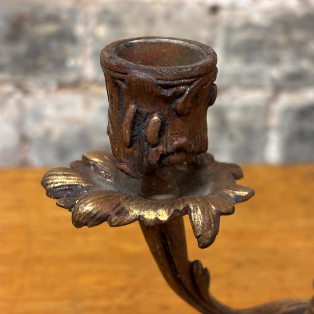 An antique cast brass candelabra table lamp featuring a scrolled base, twin candle sconces, two electrical fittings, and a finial top. View III
