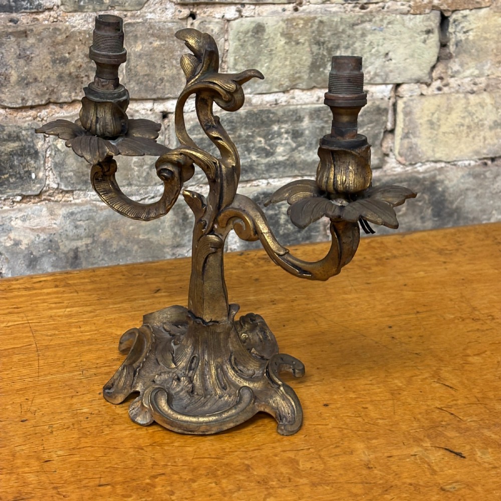 A two-arm gilt brass table lamp base featuring sculpted leaf motifs, curved organic branches, and a broad scrolling base. View II