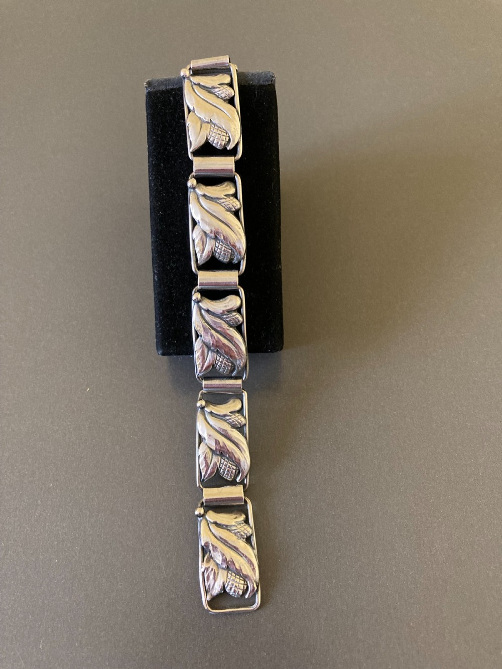 A segmented silver link bracelet featuring repeating organic botanical motifs in a mid-century Scandinavian style. View IV