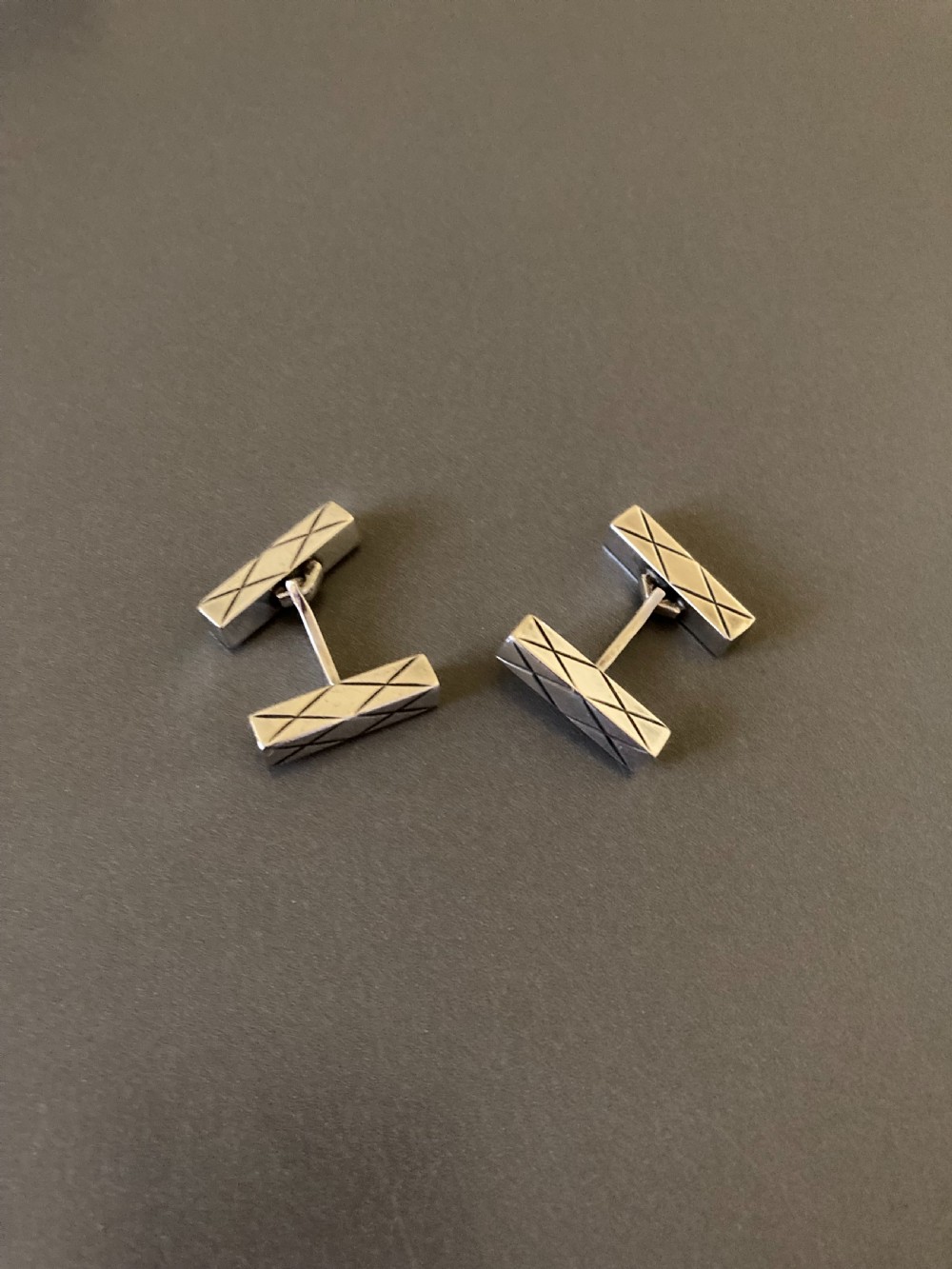 A pair of rectangular mid-century Danish silver cufflinks featuring engraved geometric line patterns. View II