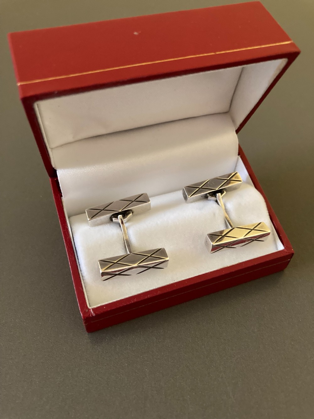 A pair of rectangular mid-century Danish silver cufflinks featuring engraved geometric line patterns. View IV
