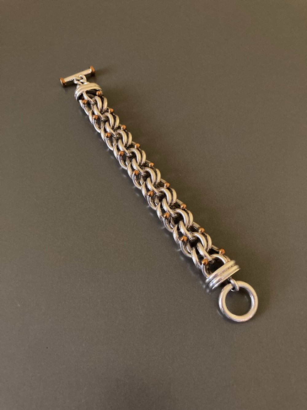 An intricate mid-century Danish silver link bracelet featuring interlocking metalwork and a toggle clasp.