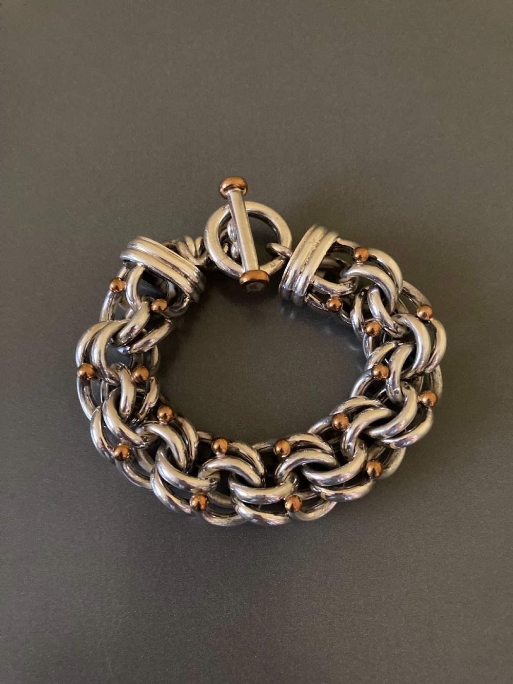 An intricate mid-century Danish silver link bracelet featuring interlocking metalwork and a toggle clasp. View IV