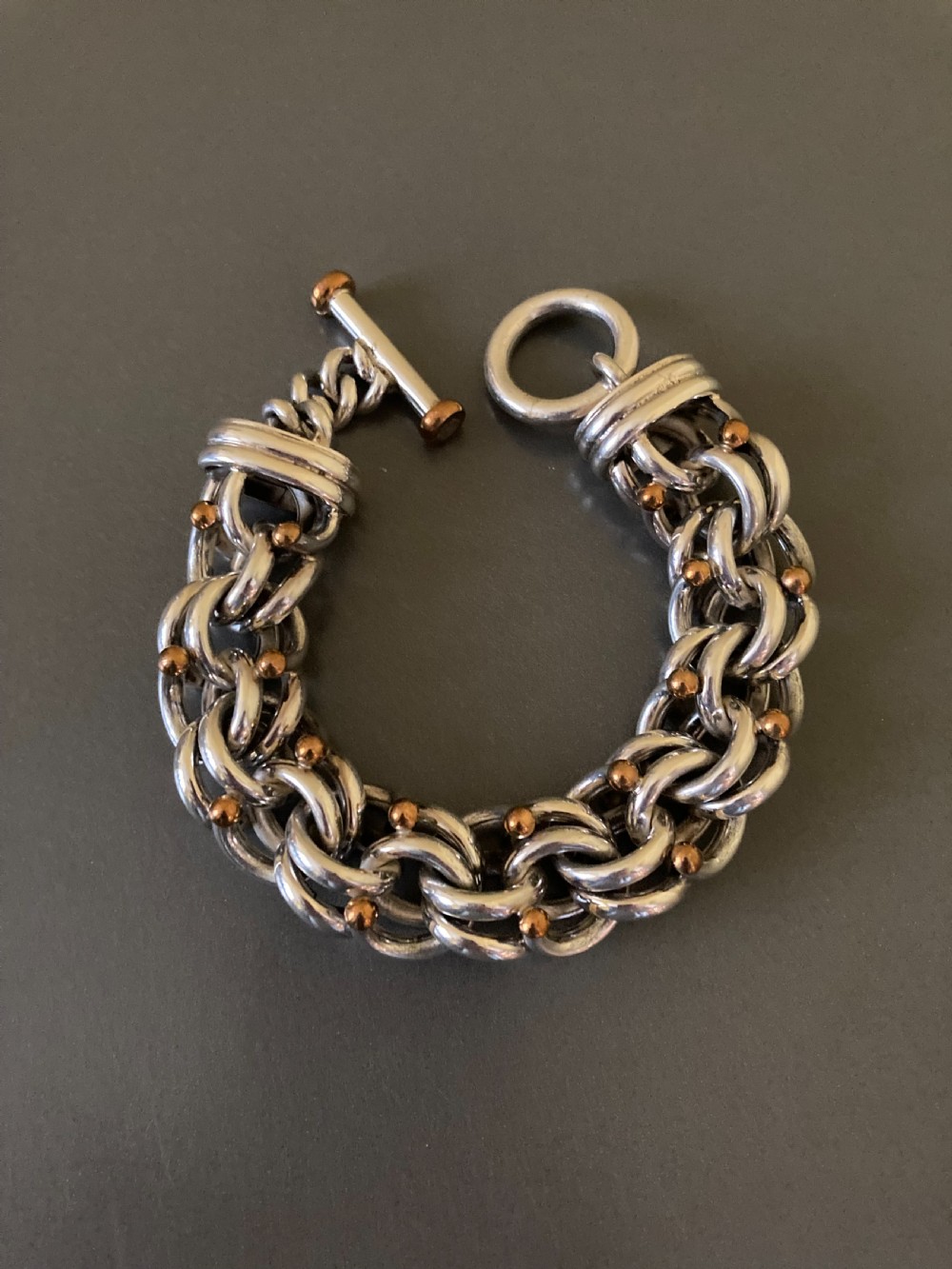 An intricate mid-century Danish silver link bracelet featuring interlocking metalwork and a toggle clasp. View V
