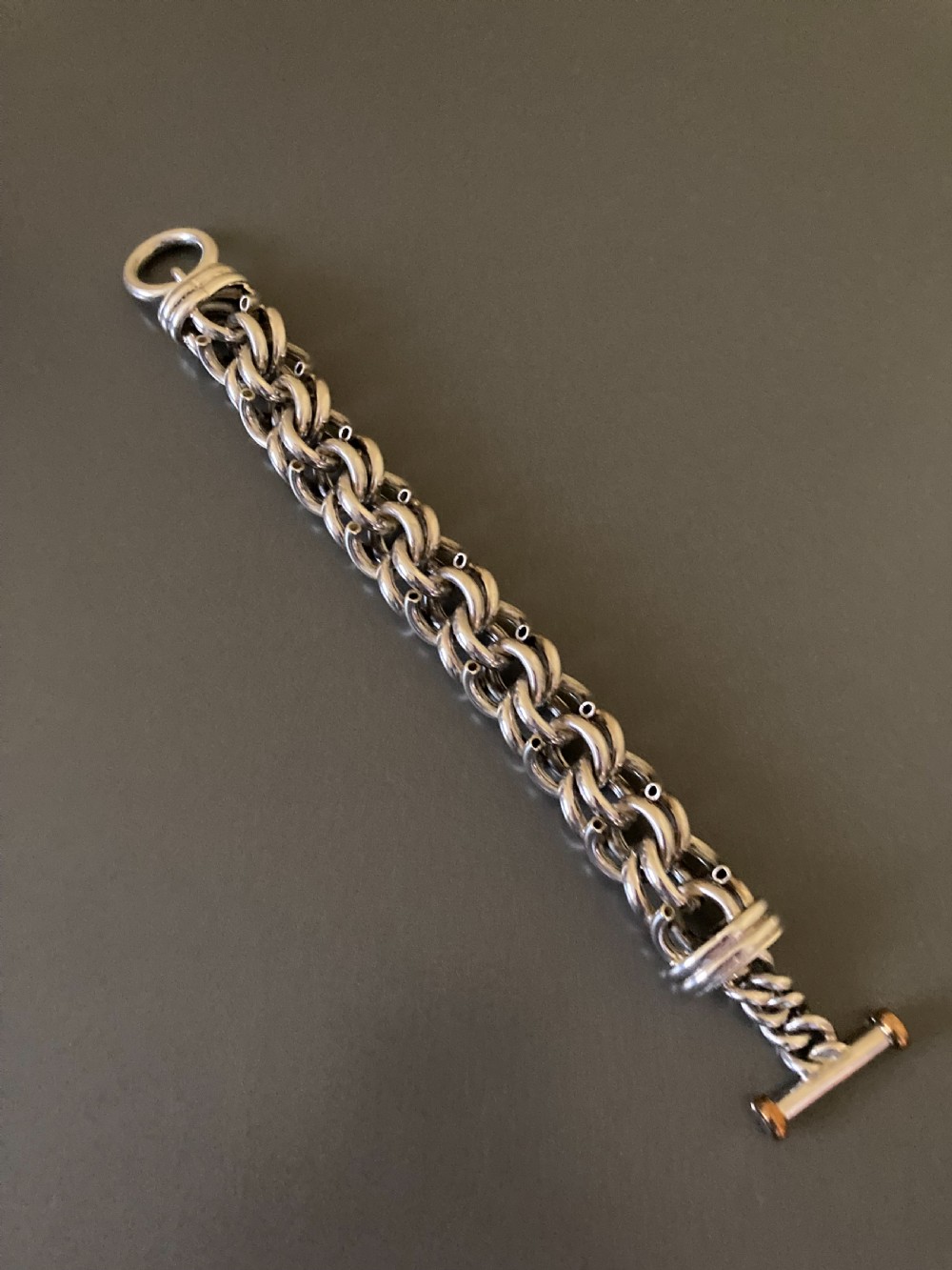 An intricate mid-century Danish silver link bracelet featuring interlocking metalwork and a toggle clasp. View VI