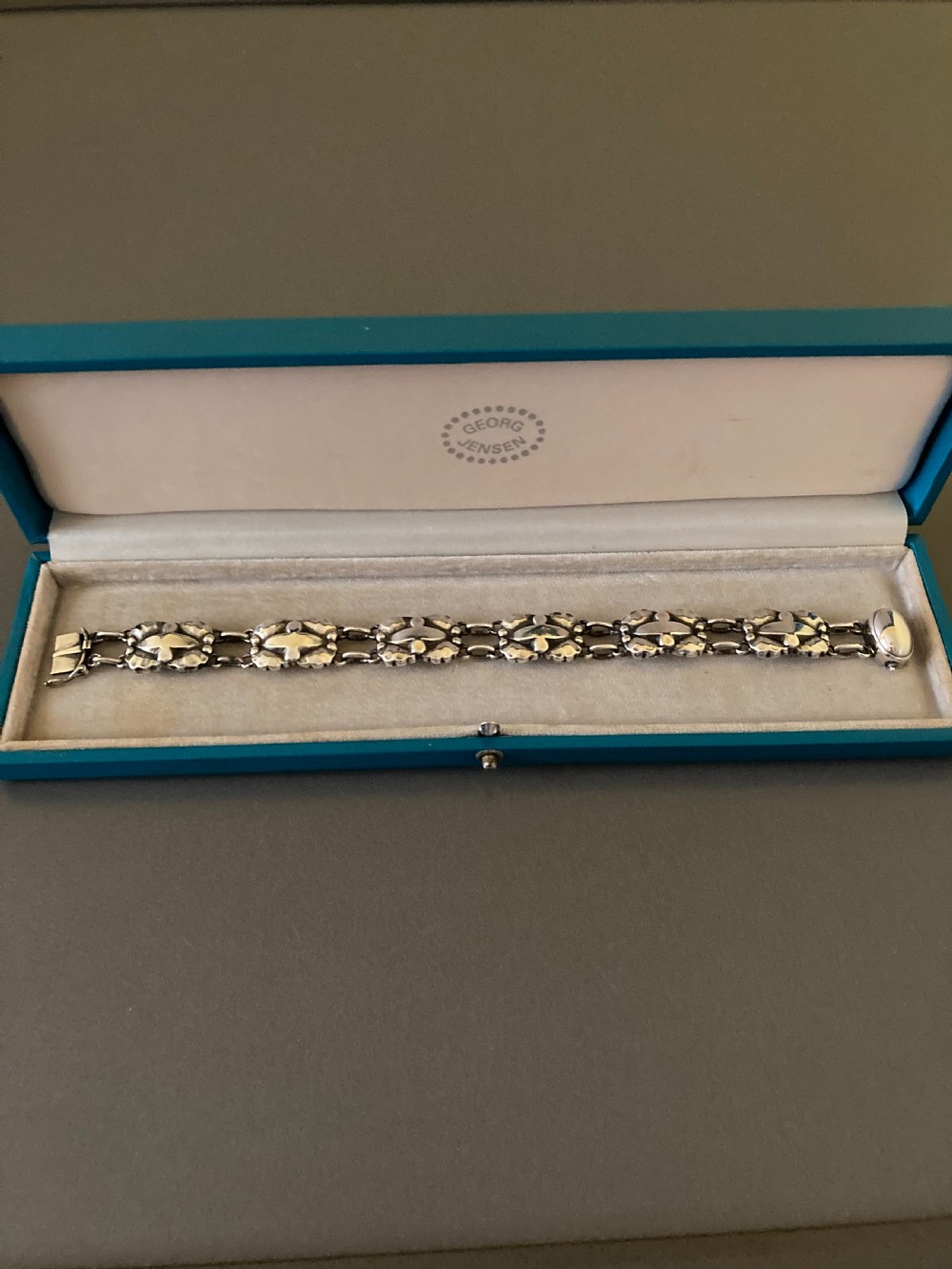 A vintage Georg Jensen sterling silver link bracelet featuring repeating organic floral motifs and a secure clasp. View II