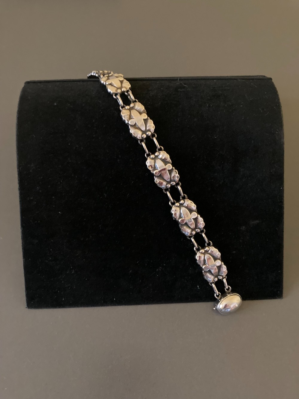 A vintage Georg Jensen sterling silver link bracelet featuring repeating organic floral motifs and a secure clasp. View IV