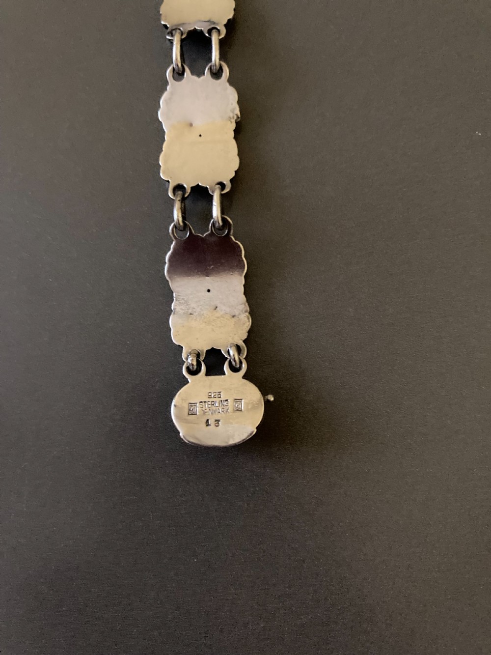 A vintage Georg Jensen sterling silver link bracelet featuring repeating organic floral motifs and a secure clasp. View V