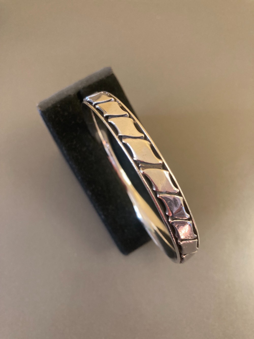 A 1960s Danish sterling silver bangle featuring a carved geometric pattern around the exterior band. View III