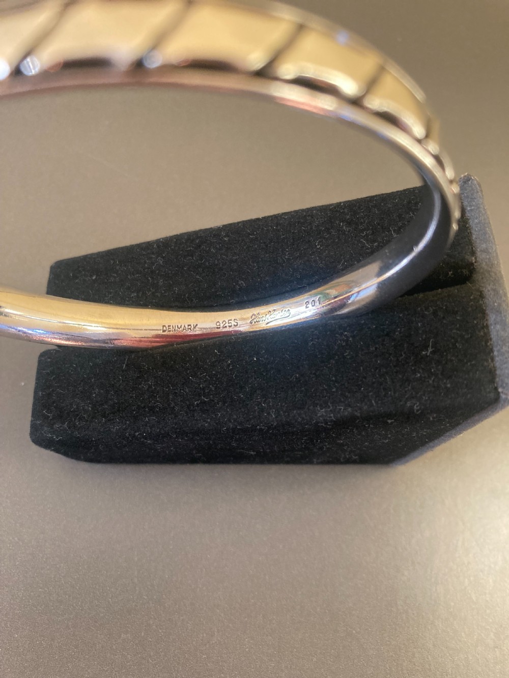 A 1960s Danish sterling silver bangle featuring a carved geometric pattern around the exterior band. View X