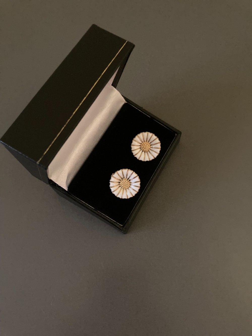 A pair of vintage Danish silver gilt daisy earrings featuring white enamelled petals and a textured gold centre. View V