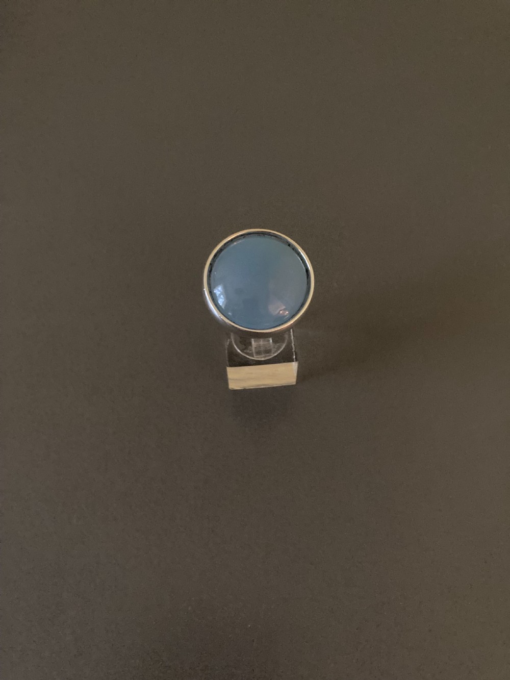 A vintage Georg Jensen sterling silver ring featuring a smooth, round blue chalcedony cabochon set in a minimalist bezel.