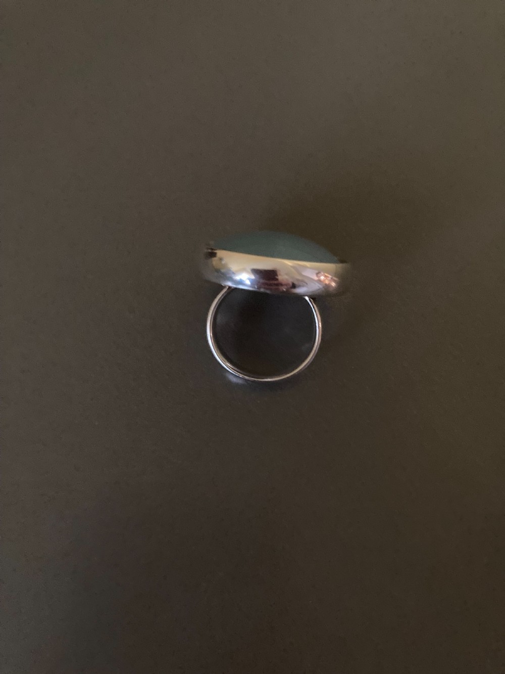 A vintage Georg Jensen sterling silver ring featuring a smooth, round blue chalcedony cabochon set in a minimalist bezel. View V