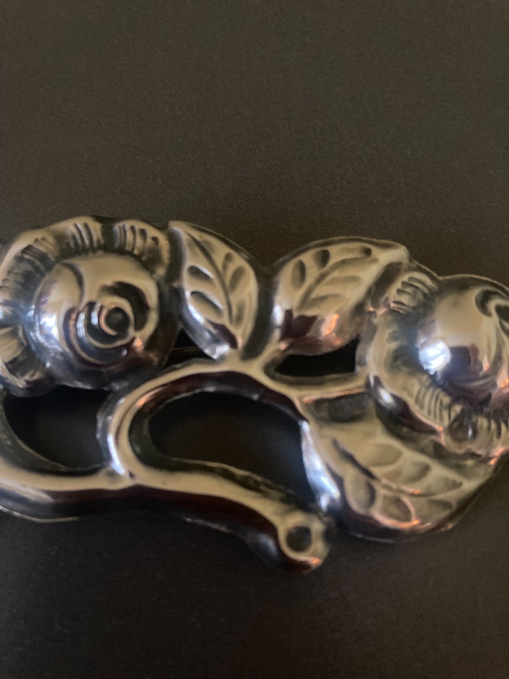 A 1920s Danish silver brooch featuring an openwork floral design of three sculpted rose blossoms and leaves. View II