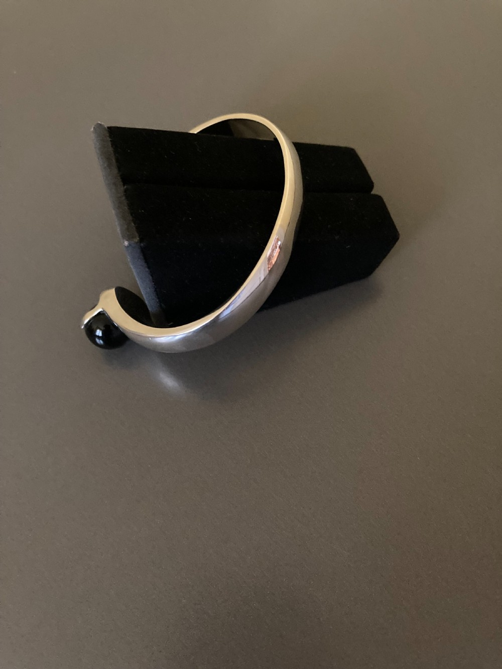 A 1960s Danish silver bangle featuring terminal black onyx spheres by Kurt Nielsen. View IV