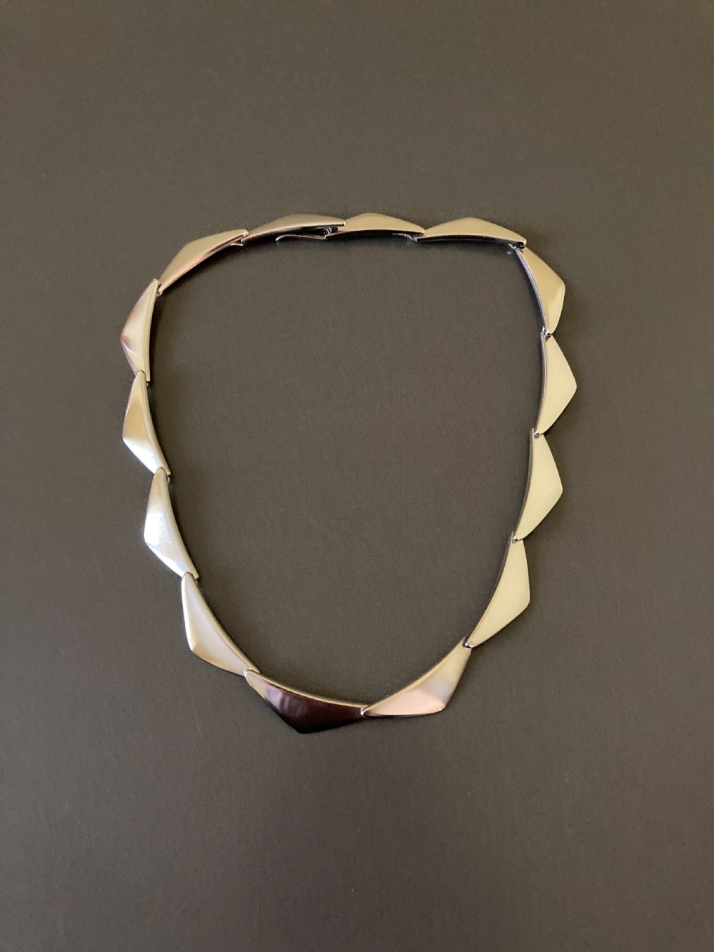 A vintage Georg Jensen silver Peak necklace featuring articulated geometric links arranged in a circular formation.