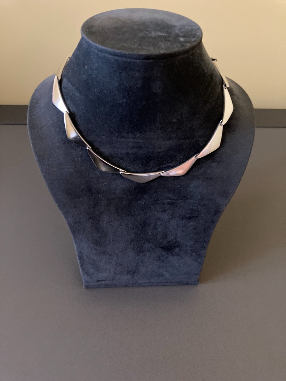 A vintage Georg Jensen silver Peak necklace featuring articulated geometric links arranged in a circular formation. View III