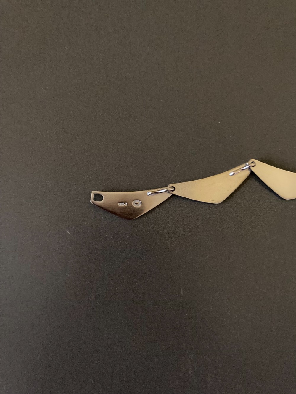 A vintage Georg Jensen silver Peak necklace featuring articulated geometric links arranged in a circular formation. View V