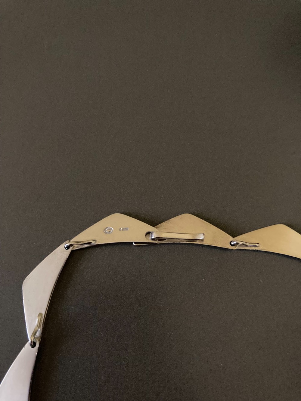 A vintage Georg Jensen silver Peak necklace featuring articulated geometric links arranged in a circular formation. View VII
