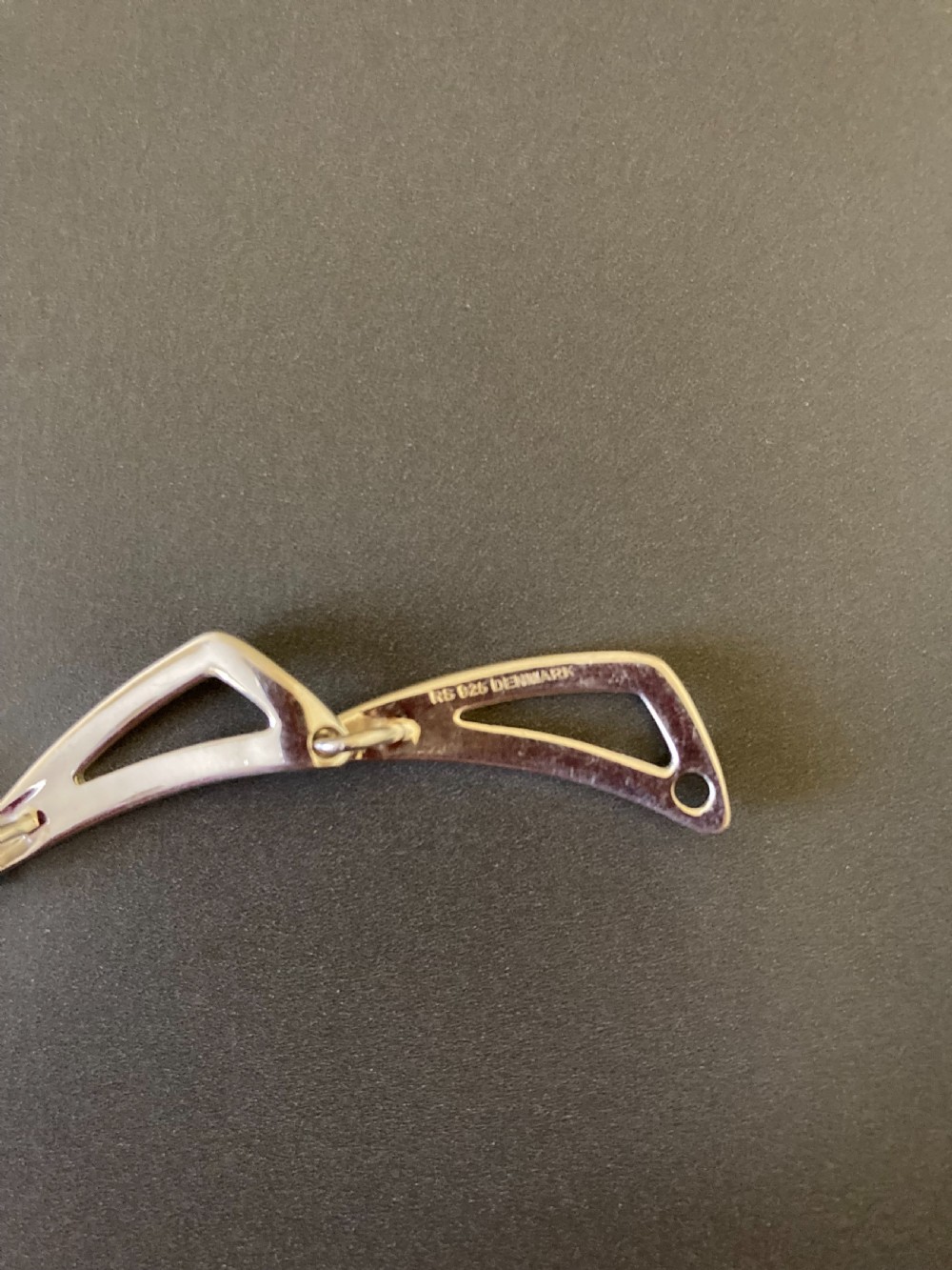 A vintage 1960s Danish sterling silver necklace featuring an articulated sequence of open triangular geometric links. View V