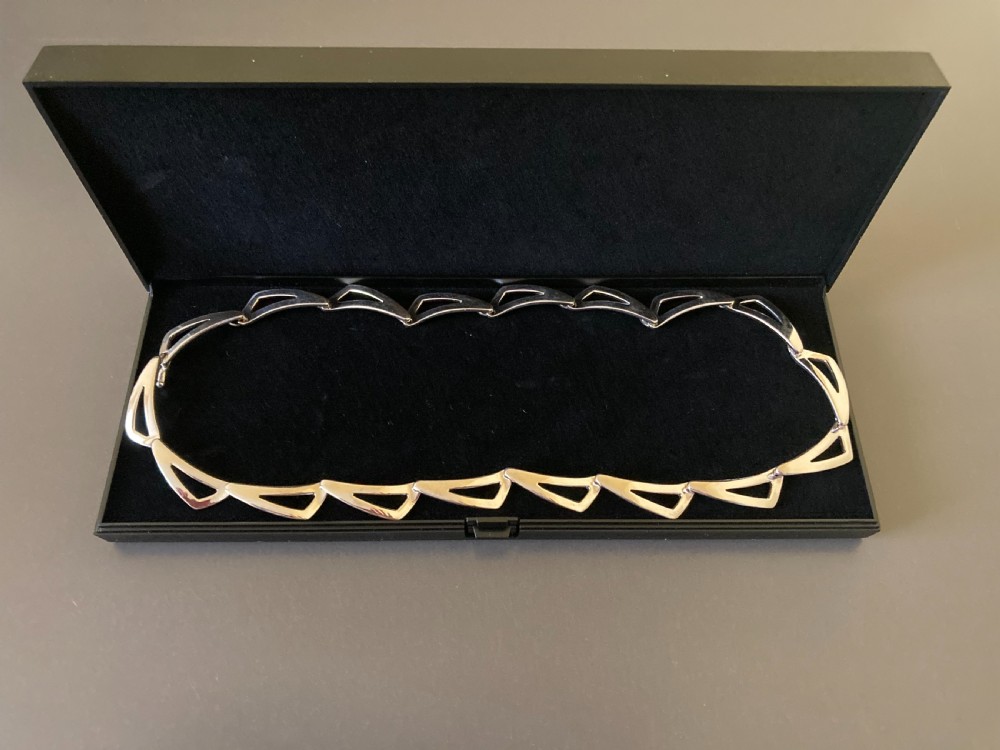A vintage 1960s Danish sterling silver necklace featuring an articulated sequence of open triangular geometric links. View VI