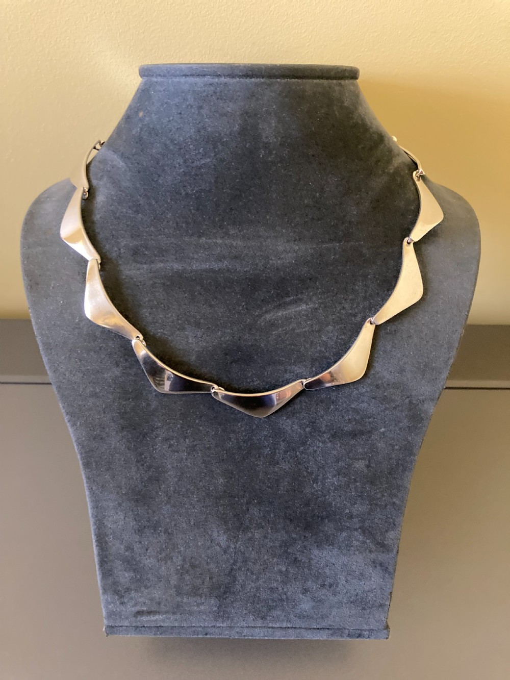 A vintage Danish silver link necklace featuring geometric, articulated segments arranged in a circular design. View III