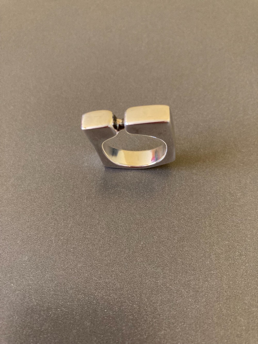 A sculptural 1960s Danish sterling silver ring featuring a geometric architectural design with a polished finish.