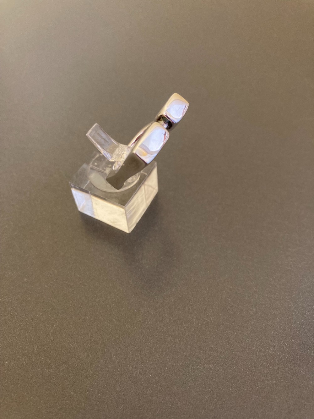 A sculptural 1960s Danish sterling silver ring featuring a geometric architectural design with a polished finish. View III