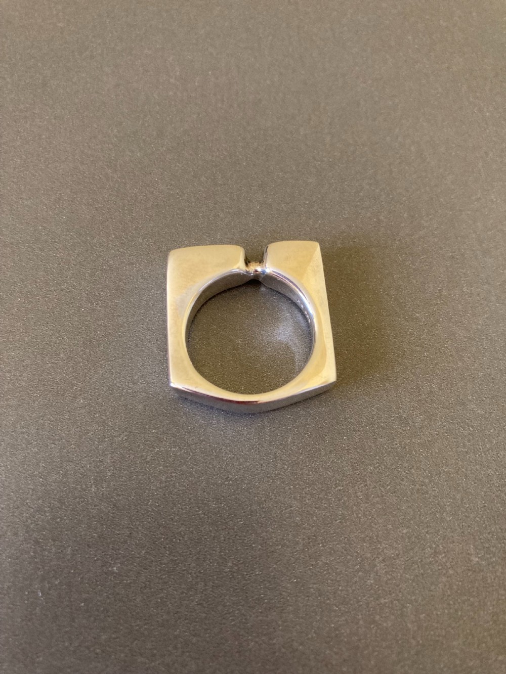 A sculptural 1960s Danish sterling silver ring featuring a geometric architectural design with a polished finish. View IV