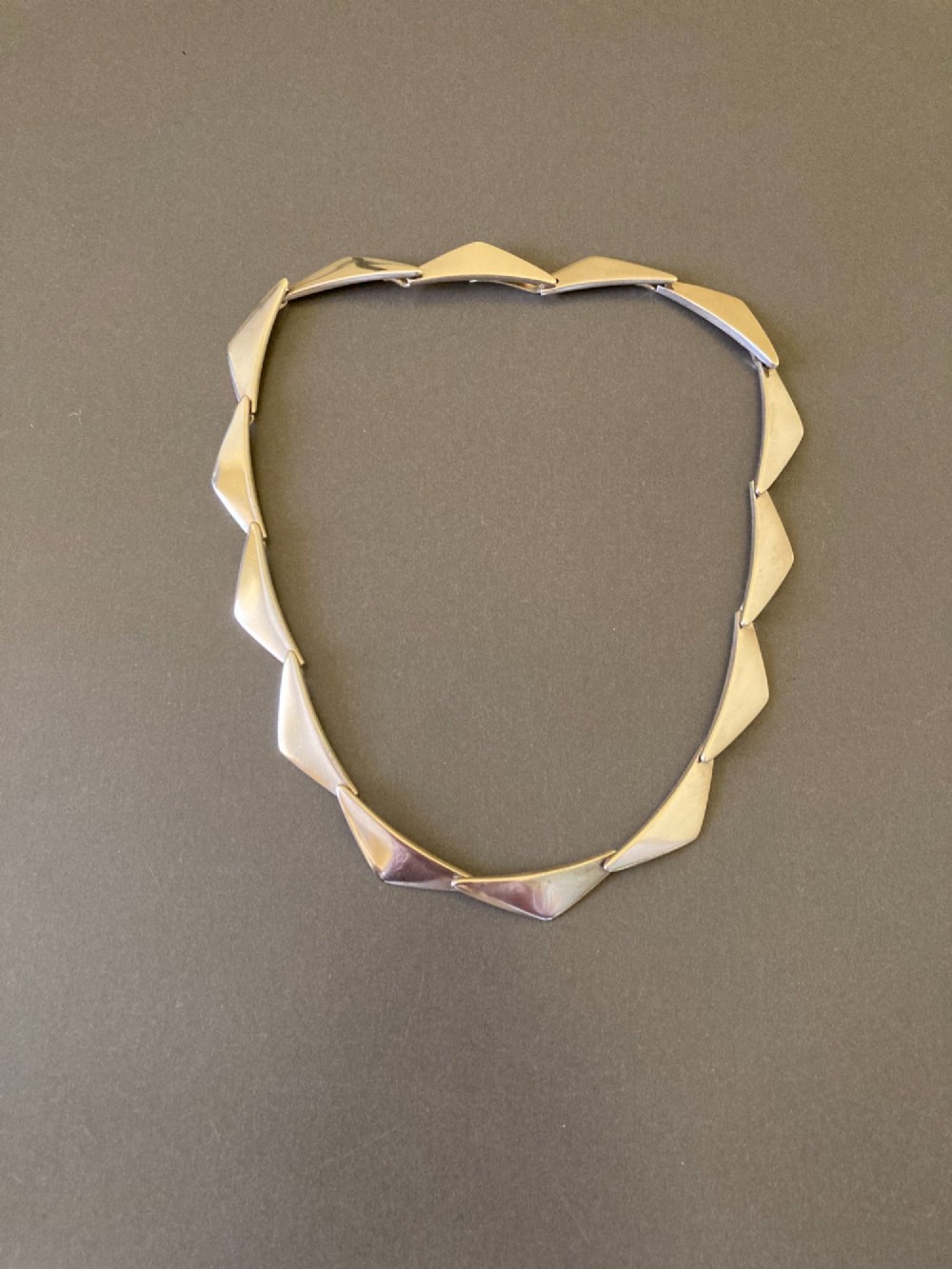 A Georg Jensen sterling silver collar necklace featuring a series of connected, angular triangular peak-shaped links.