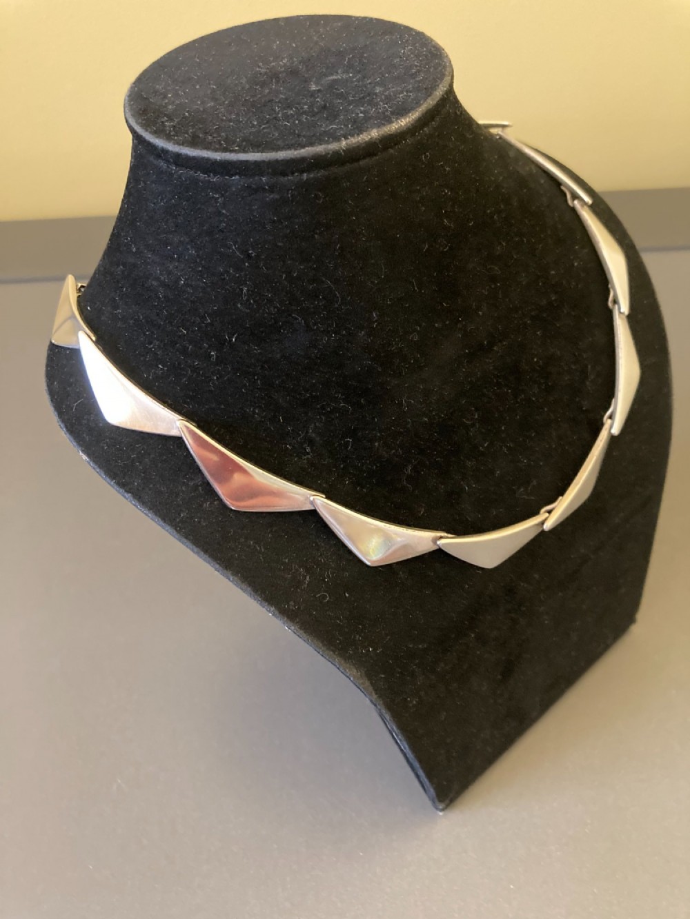 A Georg Jensen sterling silver collar necklace featuring a series of connected, angular triangular peak-shaped links. View III