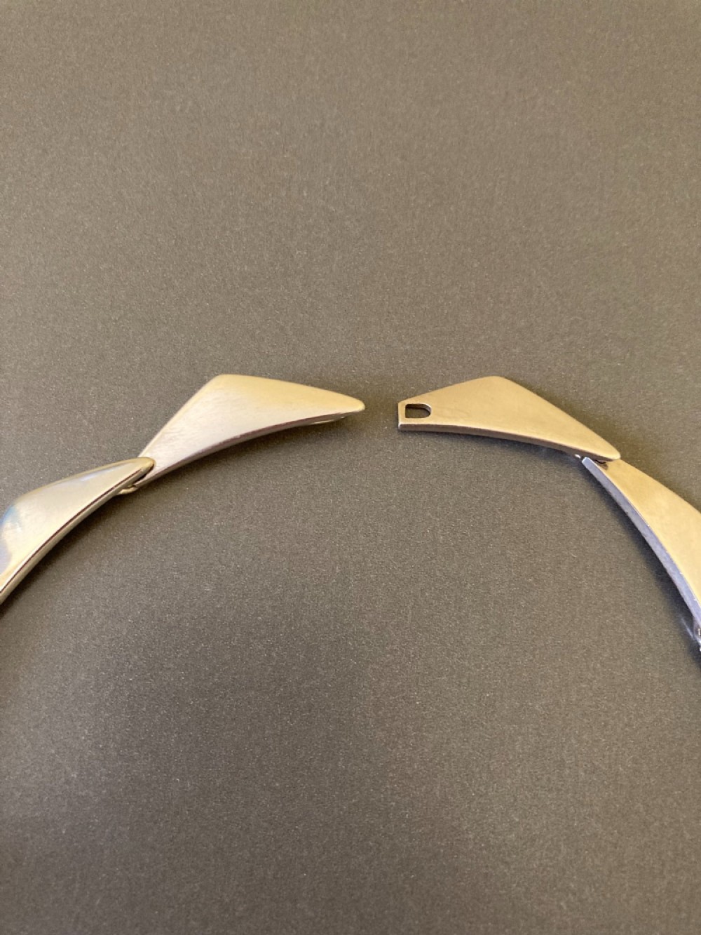 A Georg Jensen sterling silver collar necklace featuring a series of connected, angular triangular peak-shaped links. View V
