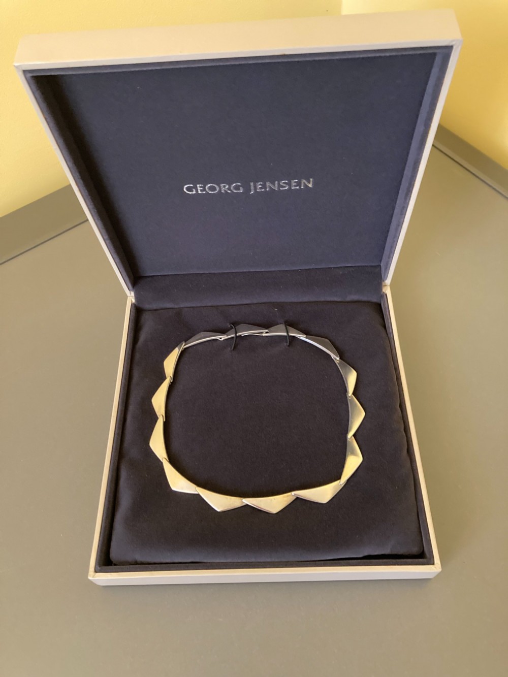 A Georg Jensen sterling silver collar necklace featuring a series of connected, angular triangular peak-shaped links. View VI