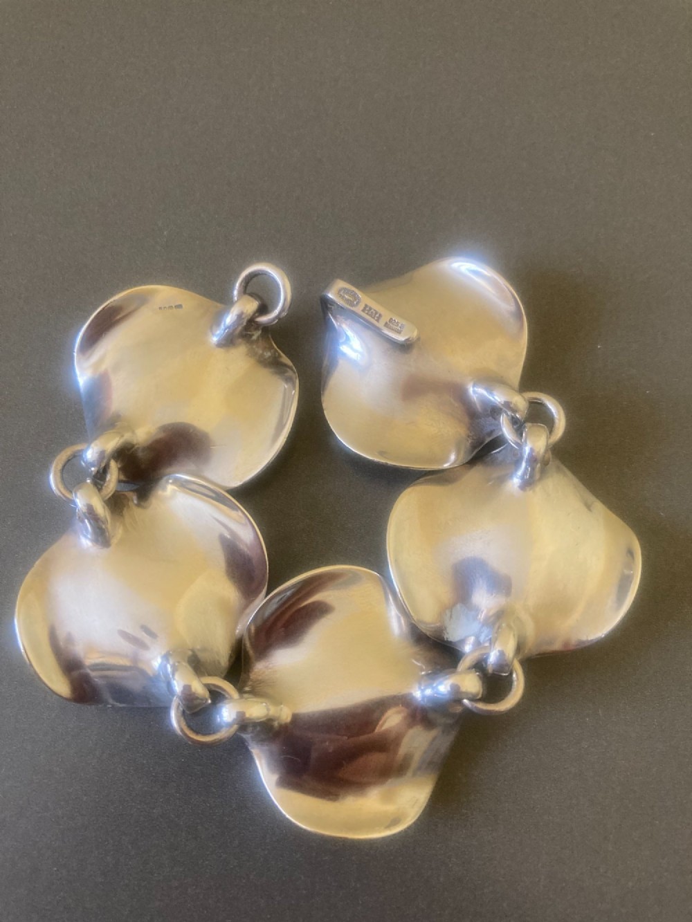 A 1960s Georg Jensen sterling silver link bracelet featuring five organic, undulating petal-formed links joined by small silver rings. View VIII