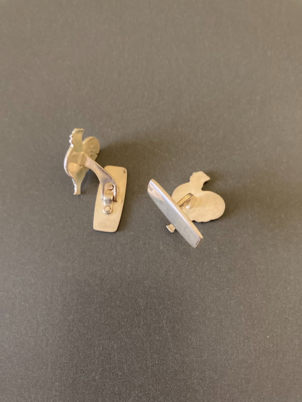 A pair of 1950s Danish sterling silver and enamel cufflinks shaped as cockerels with blue tails and white enamel bodies. View IV