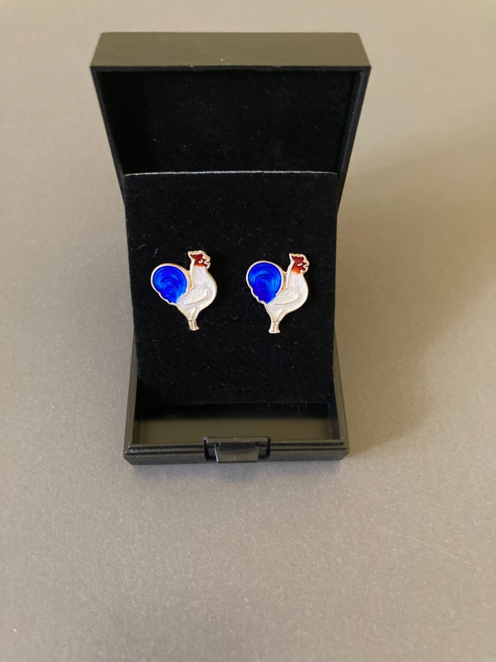 A pair of 1950s Danish sterling silver and enamel cufflinks shaped as cockerels with blue tails and white enamel bodies. View V