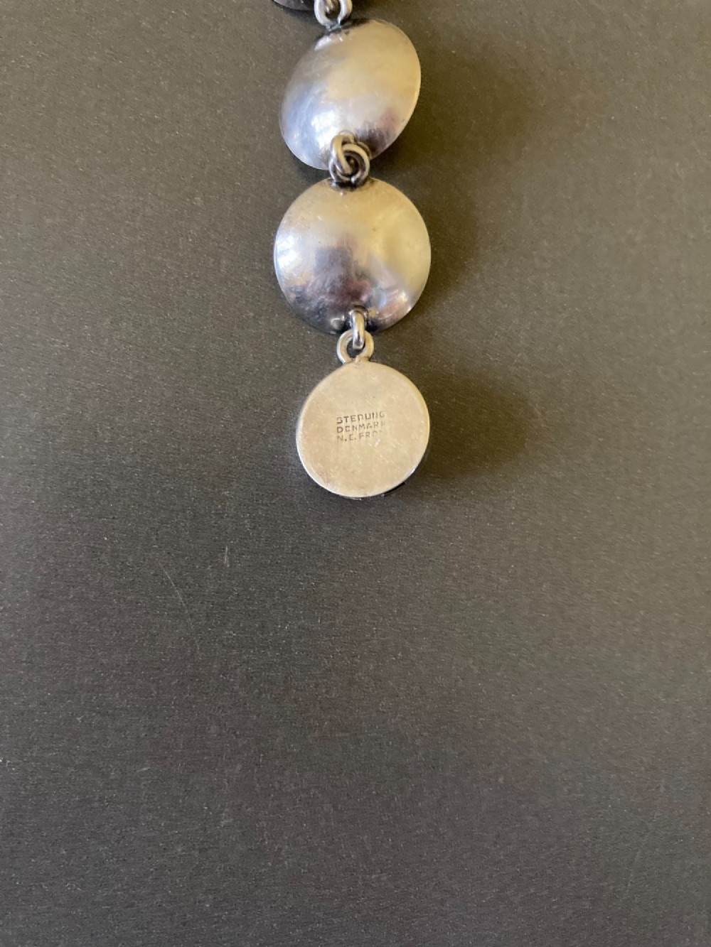 A Danish modernist sterling silver link bracelet set with round pale pink rose quartz cabochons in concaved circular mounts with a floral-detailed clasp. View VII