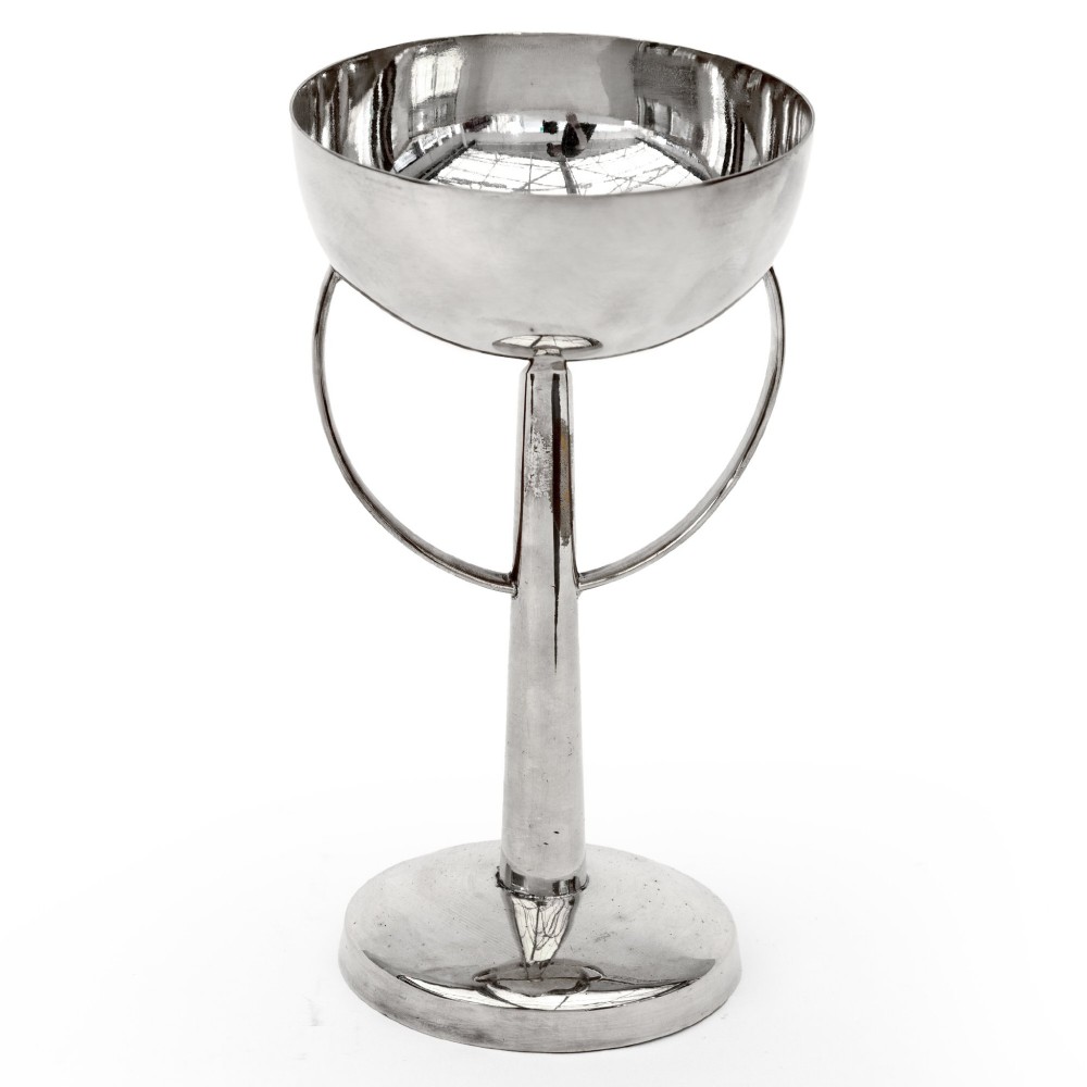 A silver-plated pedestal bonbon dish featuring a hemispherical bowl, elevated central stem, round stepped base, and two side loop handles. View II