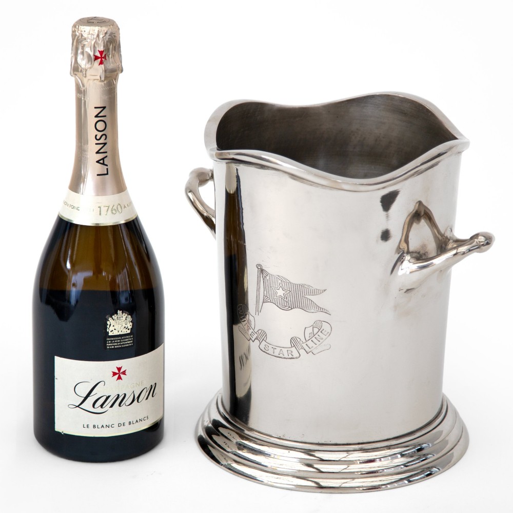 A silver-plated twin-handled wine cooler featuring a shaped rim, stepped base, and an engraved flag logo on the side. View II