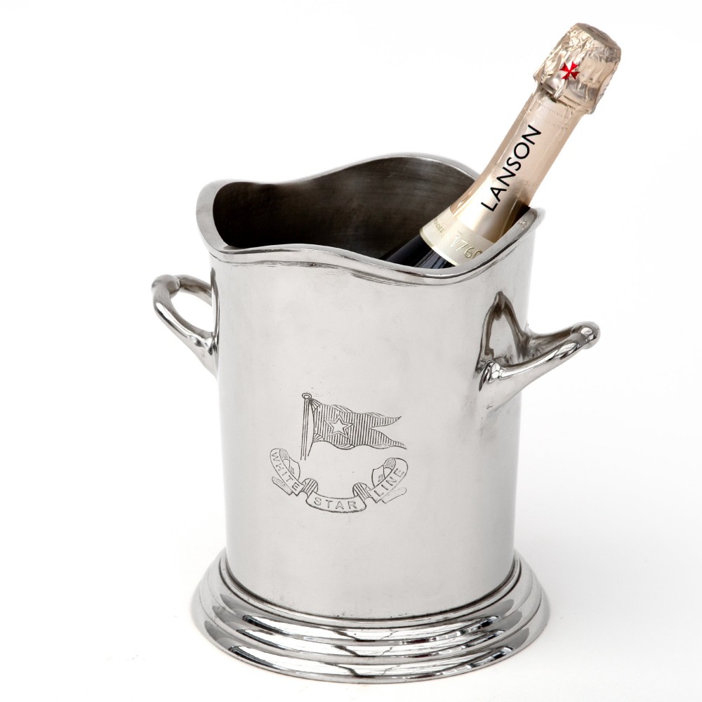 A silver-plated twin-handled wine cooler featuring a shaped rim, stepped base, and an engraved flag logo on the side. View III