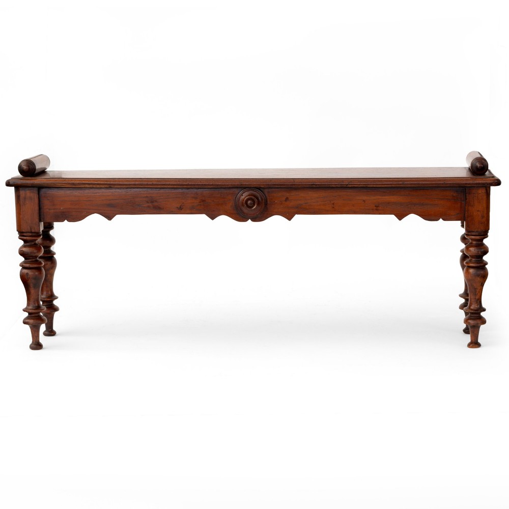 A long polished mahogany hall bench featuring turned legs, cylindrical bolster ends, and a central carved rosette on the apron. View II